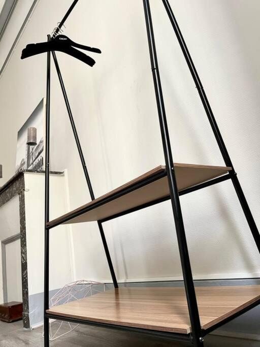 a metal stand with a shelf in a room at Haussemannien in Nevers