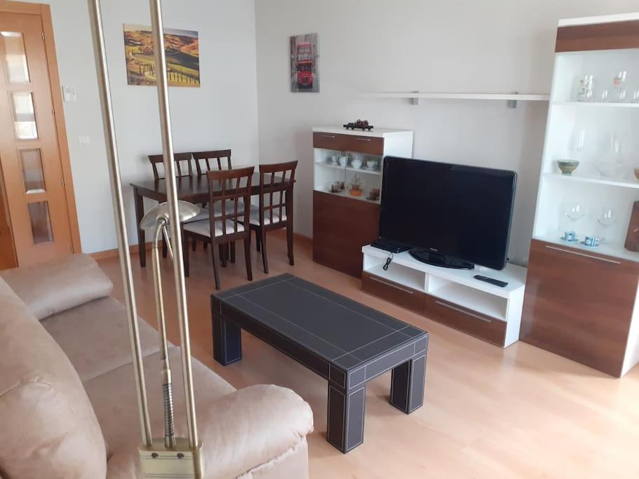 a living room with a couch and a tv and a table at El pisito de Irene in Béjar