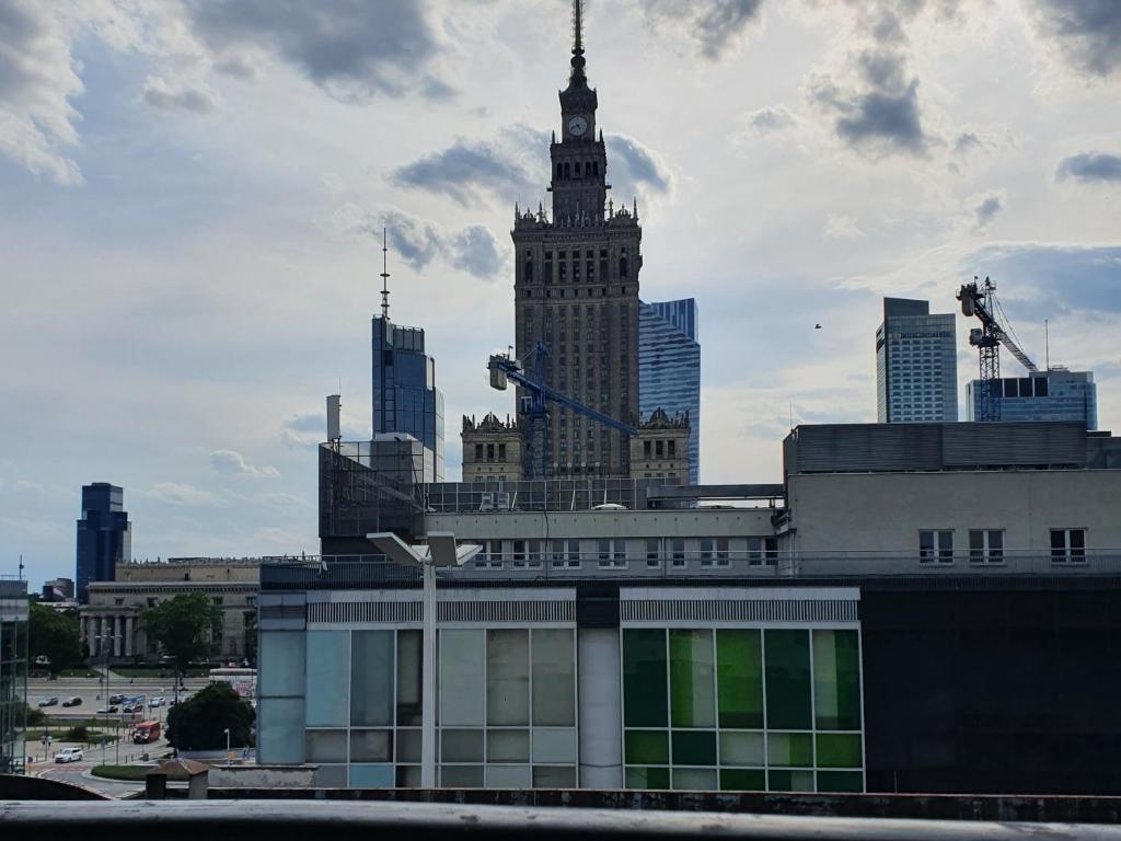 a tall building with a clock tower in a city at OhMyHome Złota Colors in Warsaw