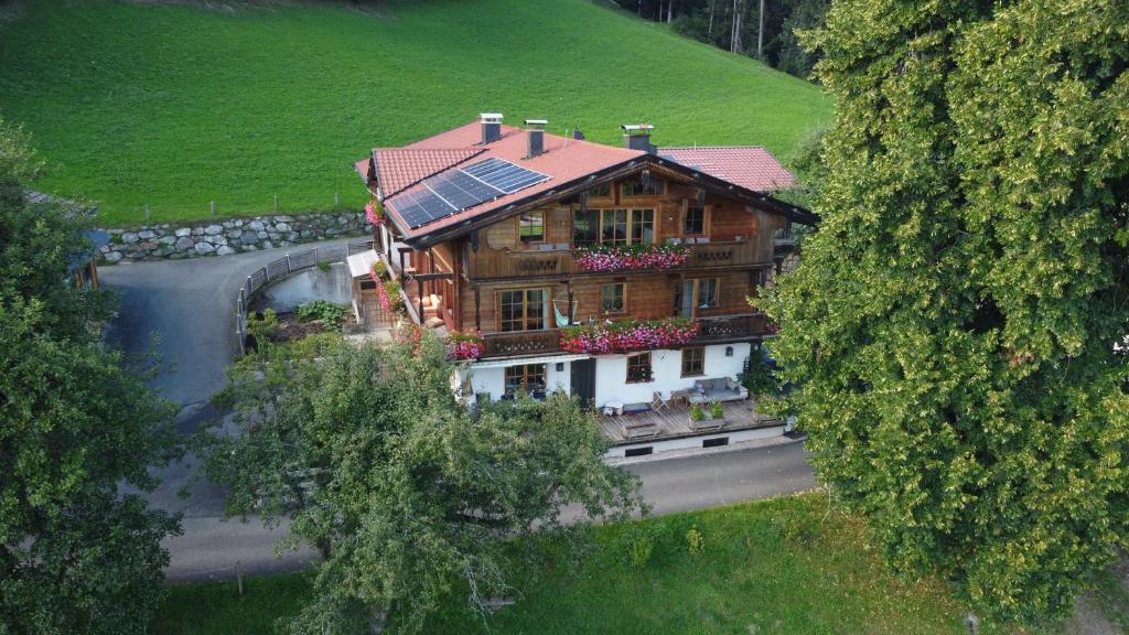 a house with solar panels on top of it on a road at Farnreit in Brixen im Thale