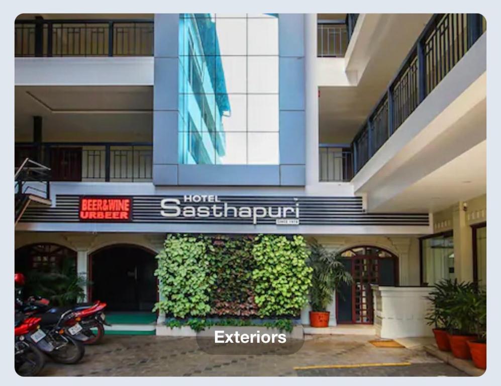 a building with a sign for a sasquatch hotel at Hotel Sasthapuri in Kozhikode
