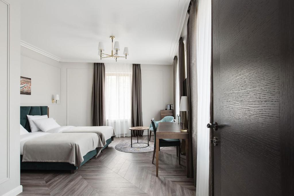 Postel nebo postele na pokoji v ubytování VICTORIA Hotel Klaipėda