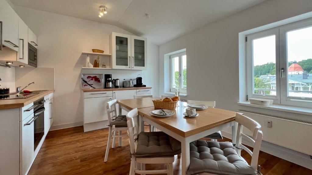 eine Küche mit einem Tisch und Stühlen im Zimmer in der Unterkunft Villa Sonneck - Wohnung 21 in Ostseebad Sellin