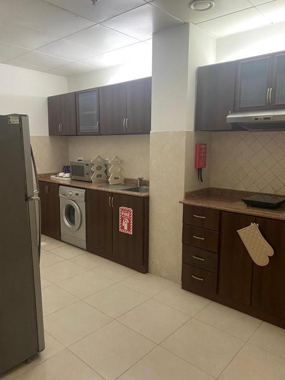 A kitchen or kitchenette at Corp Executive Hotel Doha Suites