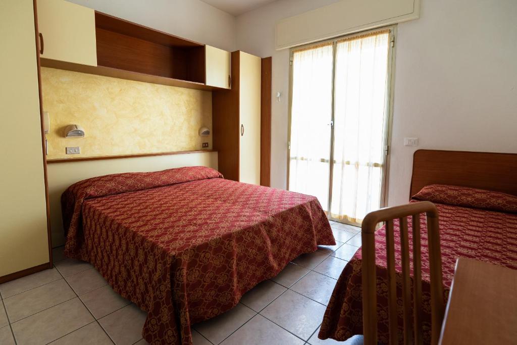 Postel nebo postele na pokoji v ubytování Hotel Zanella