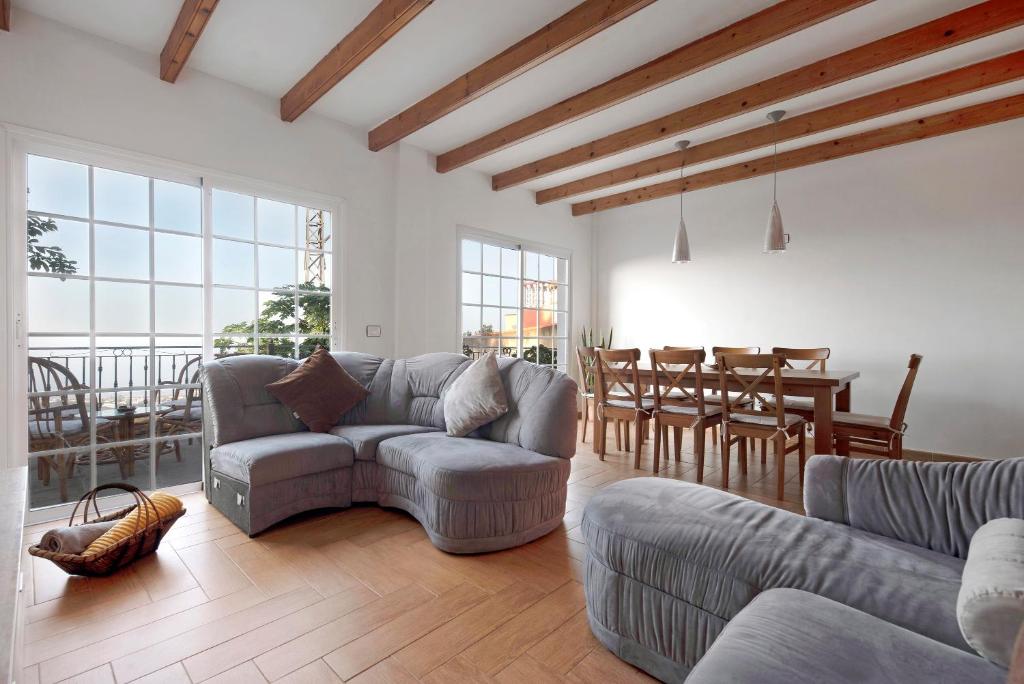 a living room with two couches and a dining room at Casa Luz in La Luz
