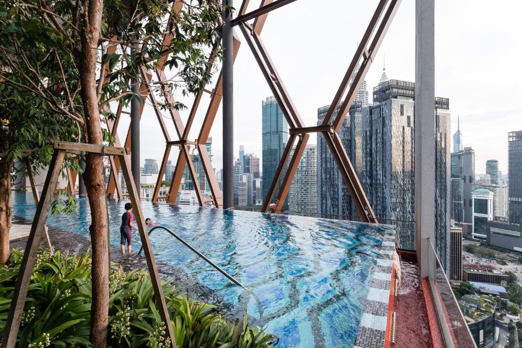 a swimming pool on the top of a skyscraper at Scarletz KLCC Studio Suites 4 pax Luxury Modern Style WiFi 100Mbps in Kuala Lumpur