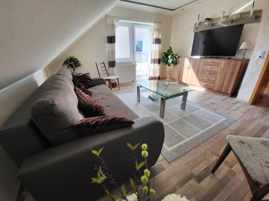 a living room with a couch and a table at Schöne Wohnung mit eigenem Eingang und Parkplatz in Fulda