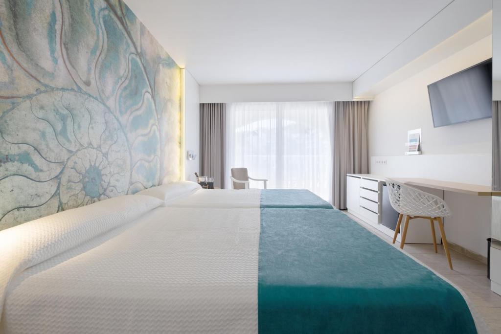 Postel nebo postele na pokoji v ubytování Gran Hotel Las Fuentes