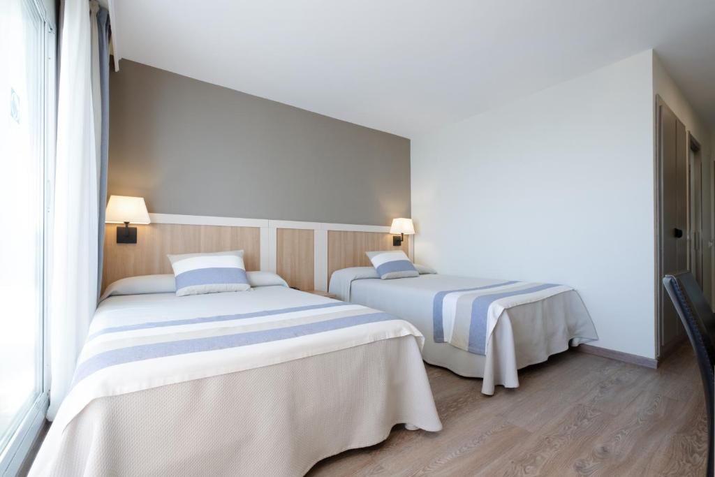 Postel nebo postele na pokoji v ubytování Gran Hotel Las Fuentes