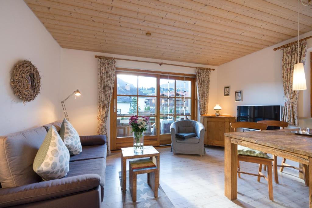 a living room with a couch and a table at Ferienwohnungen Alpentraum - Pusteblume in Obermaiselstein