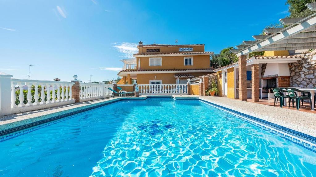 a swimming pool in front of a house at Villa el Cerrillo Málaga - Churriana by Ruralidays in Málaga