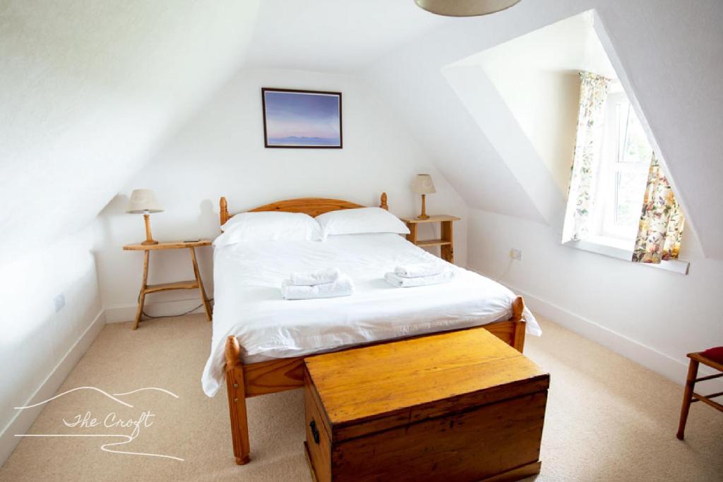 a bedroom with a bed in a attic at The Croft Cottage - near Aviemore in Aviemore