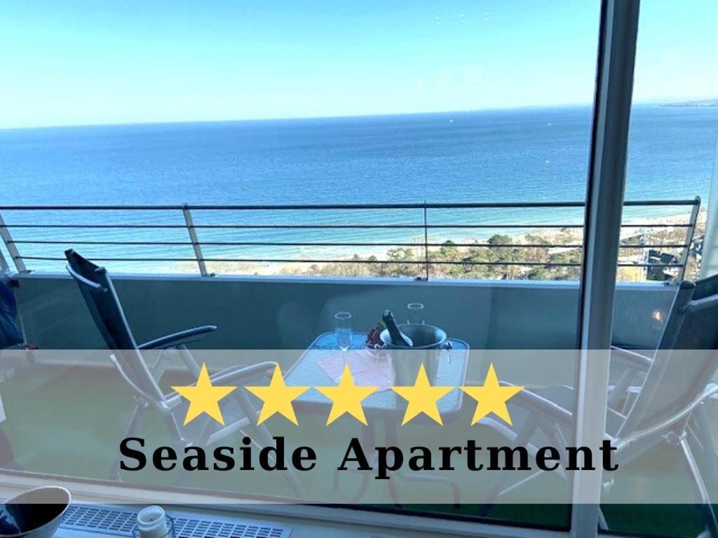 a table with five yellow stars on a balcony at Top - Seaside Appartement mit Meerblick in Timmendorfer Strand