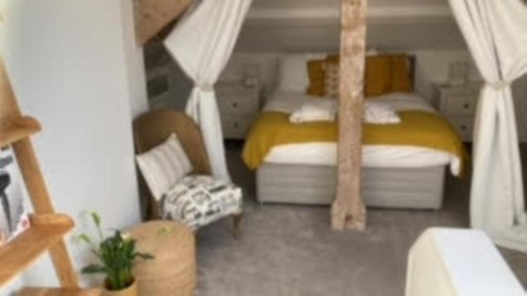 1 dormitorio pequeño con 1 cama y 1 silla en Flat 6 George Street, en Teignmouth