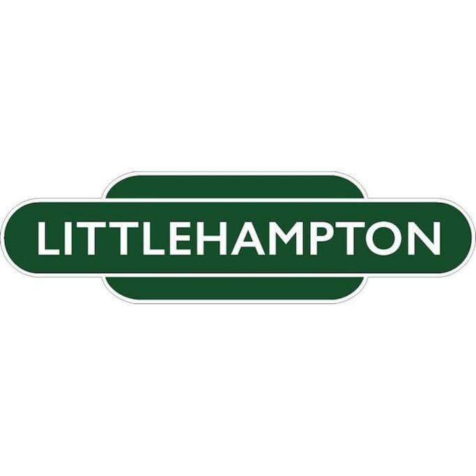 a green and white sign that reads littrification at River Road, Littlehampton, Executive Apartment in Littlehampton