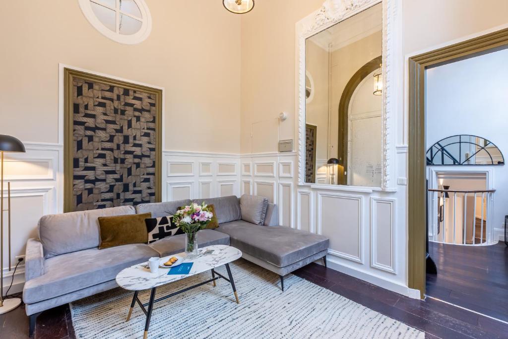 a living room with a couch and a table at Sweet Inn - Friedland in Paris