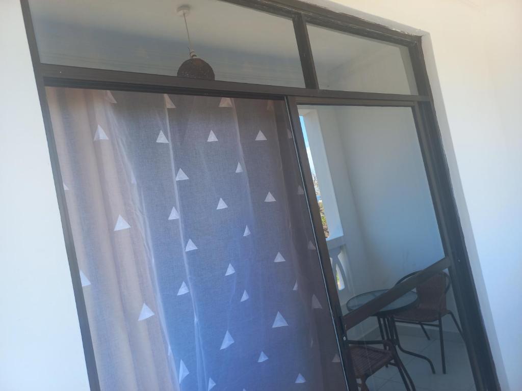 a window with a chair in front of it at Maranda Deluxe Double Seaview room - B&B with pool. in Ukunda