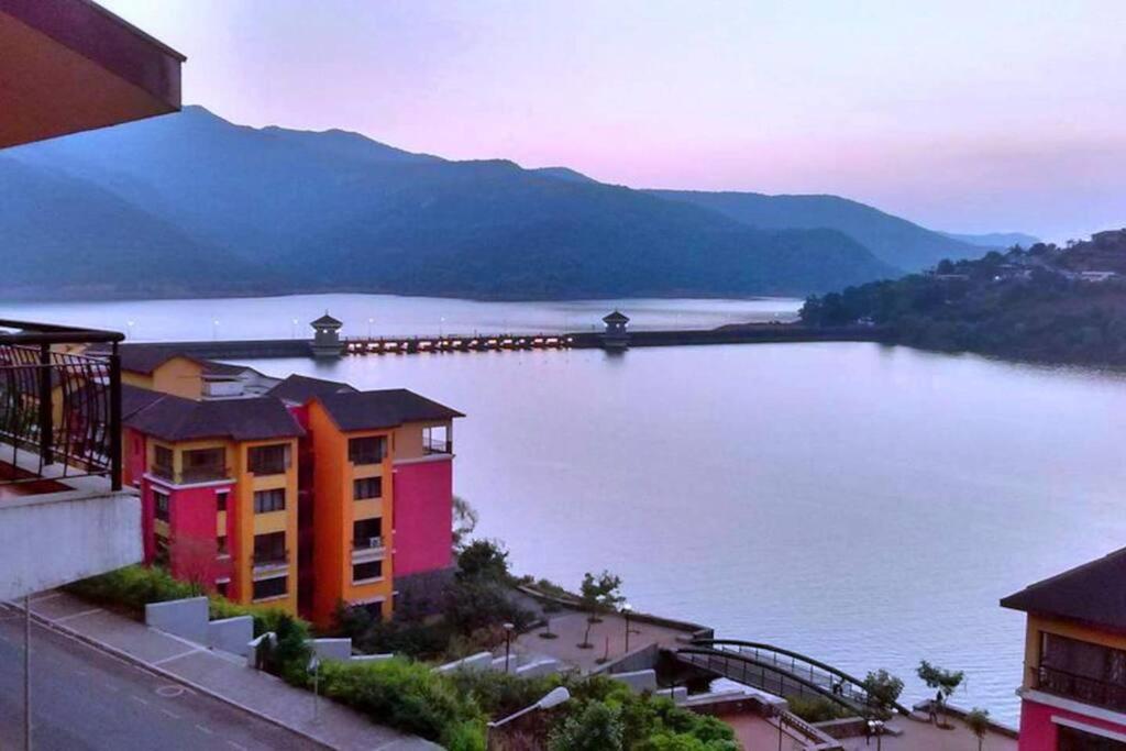 a view of a large body of water with buildings at Portofino in Lavasa