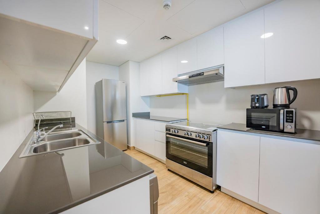Kuchyň nebo kuchyňský kout v ubytování Expo Village Serviced Apartments