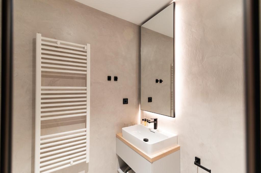 a bathroom with a sink and a mirror at Hotel A&#39;mare in Zadar