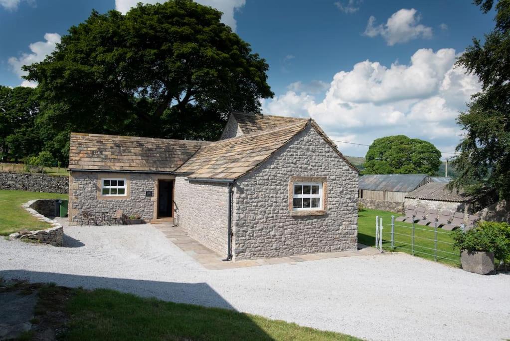 una casa de piedra con una entrada delante de ella en Long Roods cottage, en Bakewell