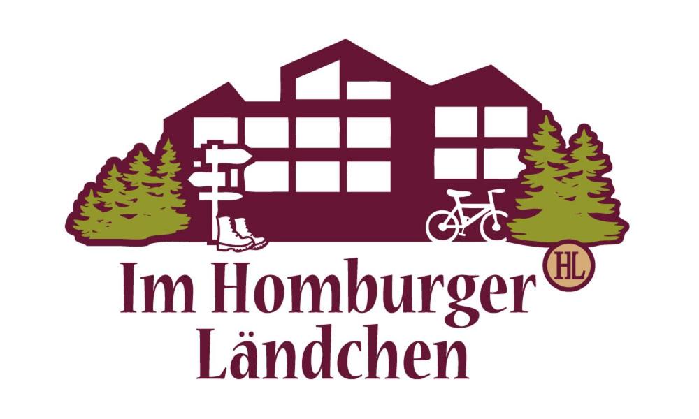 a house with trees and a bicycle and the words in homesteader lader at Hotel im Homburger Ländchen in Nümbrecht