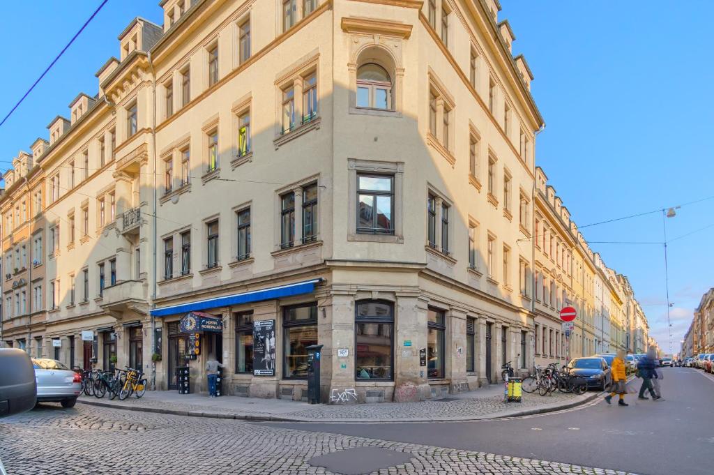 a large building on a street in a city at Hostel Mondpalast in Dresden