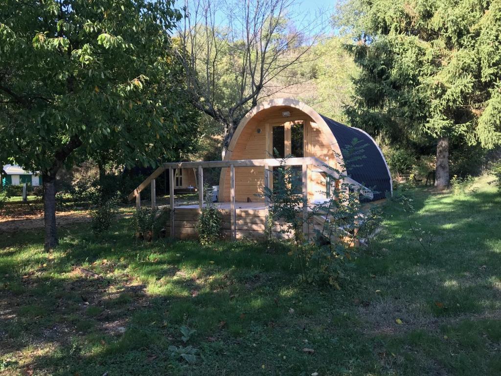a small tent in the grass in a field at Camping Les Berges Du Doux in Colombier-le-Vieux