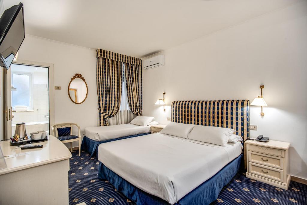 Postel nebo postele na pokoji v ubytování Hotel Napoleon