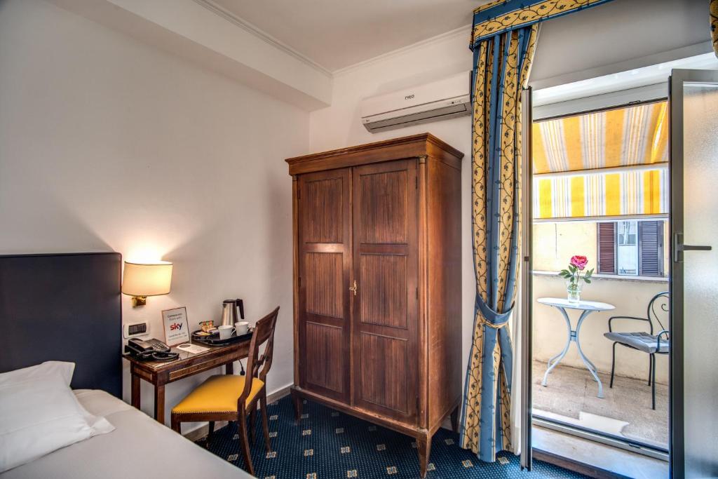 Postel nebo postele na pokoji v ubytování Hotel Napoleon