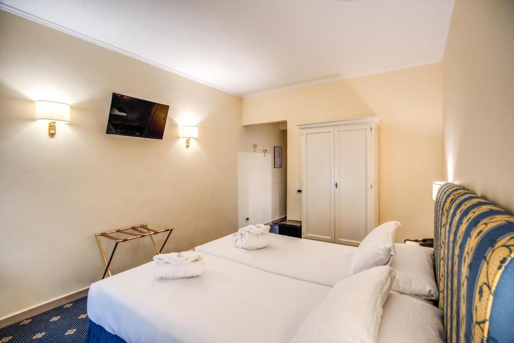 Postel nebo postele na pokoji v ubytování Hotel Napoleon