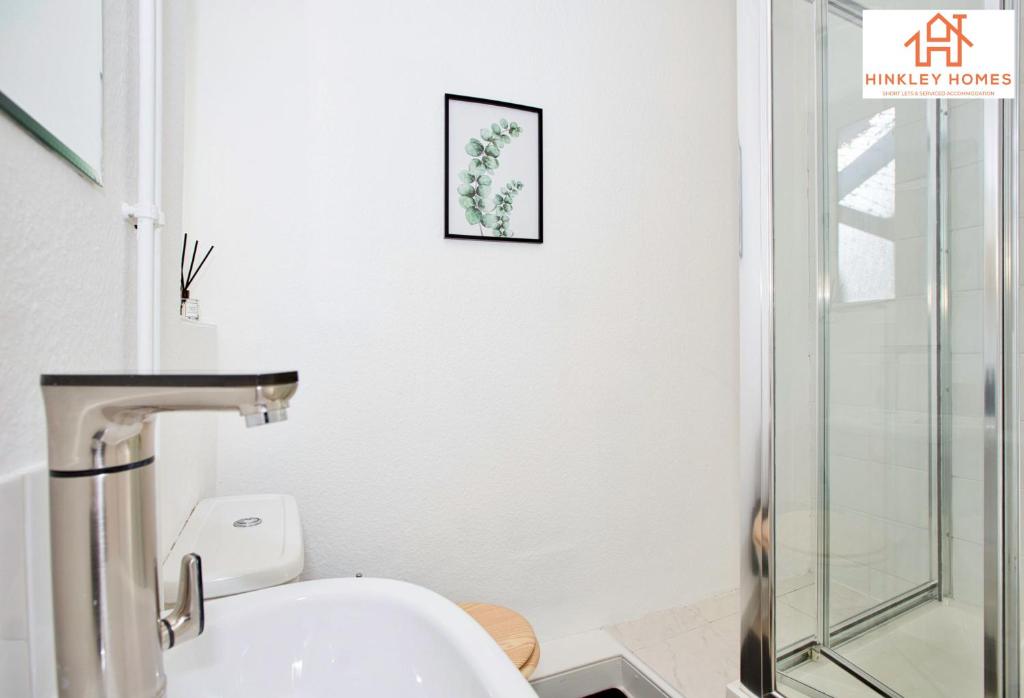 a bathroom with a toilet and a glass shower at The Highstreet Retreat - Luxurious, Central & Spacious! By Hinkley Homes Short Lets & Serviced Accommodation in Bridgwater