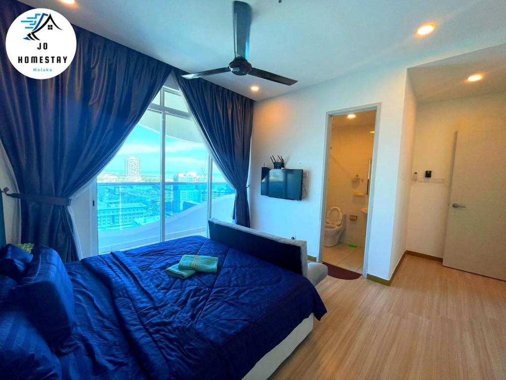 a bedroom with a blue bed and a large window at THE WAVE 3 ROOMS & 2 BATH CONDO - Near JONKER in Melaka