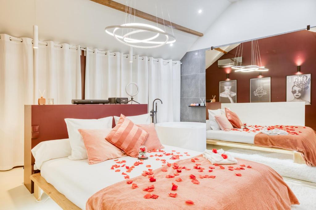 a bedroom with two beds with red flowers on it at Luxury Collection &amp; Resort in Cormeilles-en-Parisis