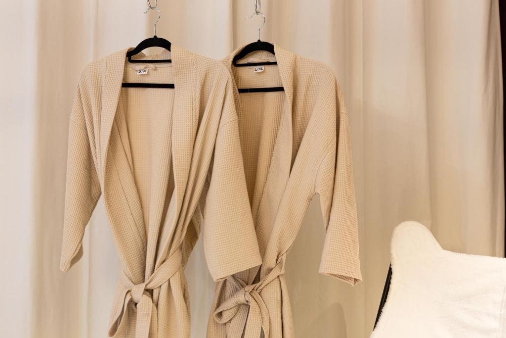 a pair of sweaters hanging on a curtain at Luxury Collection &amp; Resort in Cormeilles-en-Parisis