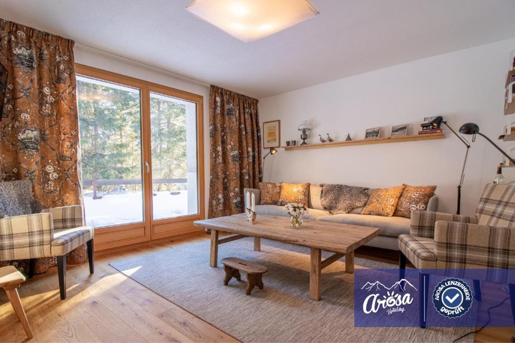 a living room with a couch and a table at Bella Riva by Arosa Holiday in Arosa