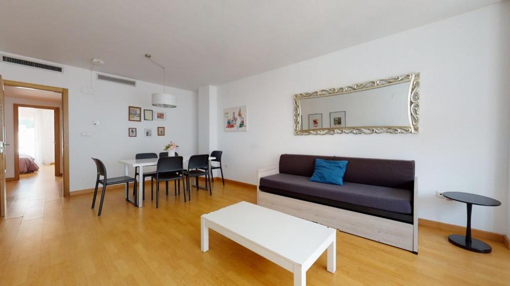 sala de estar con sofá y mesa en Flatsforyou Port, en Valencia