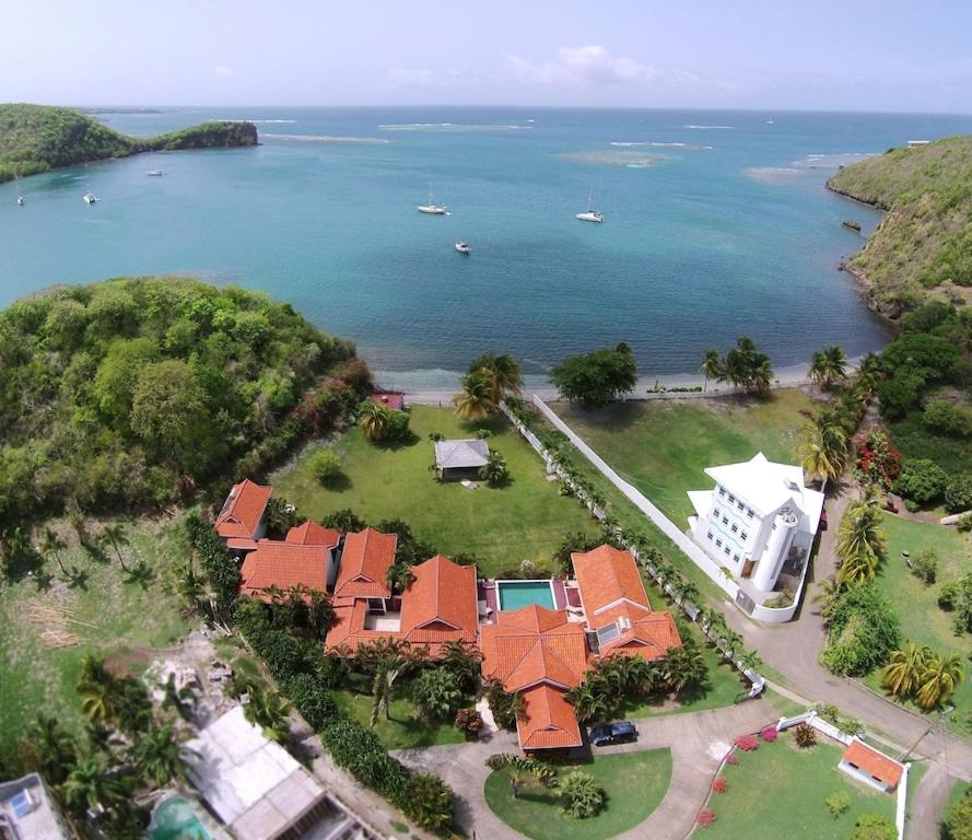 an aerial view of a house and the ocean at Bartholomew Villas in Saint Georgeʼs
