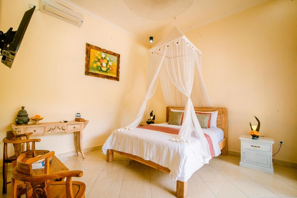 Postel nebo postele na pokoji v ubytování Villa Sekembang Ubud by Purely