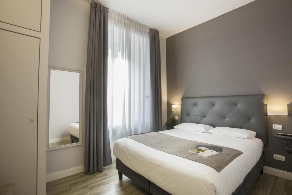 Un ou plusieurs lits dans un hébergement de l'établissement Colosseo Prestige Rooms