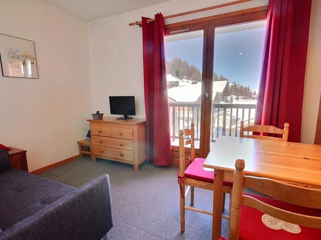 a living room with a table and a television at Studio cosy 4 pers. au pied des pistes avec balcon - FR-1-455-112 in Plagne 1800