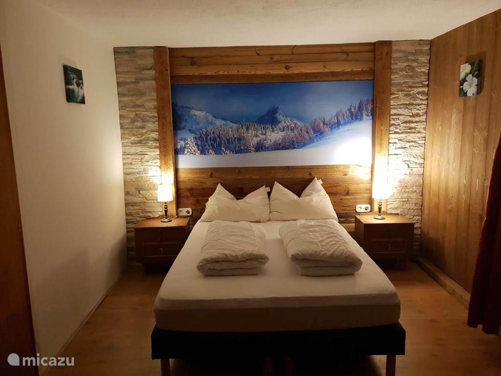 a bedroom with a bed with two pillows on it at Haus Leonie in Bramberg am Wildkogel