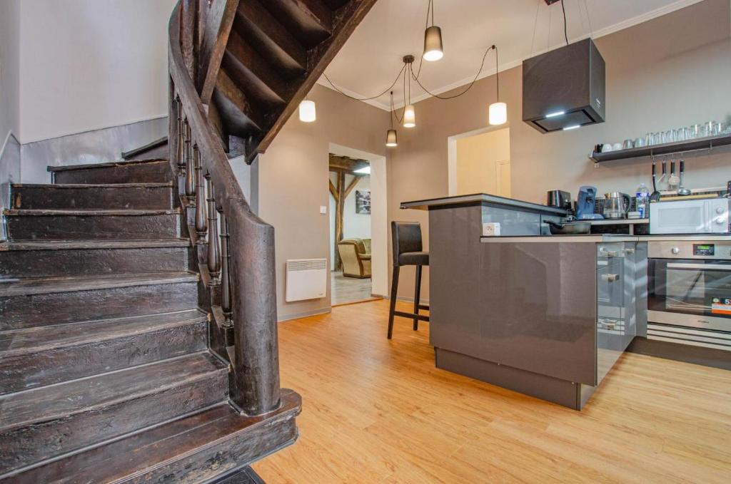 a kitchen and living room with a staircase in a house at Chambre d'hote chez Angela in Bar-sur-Aube