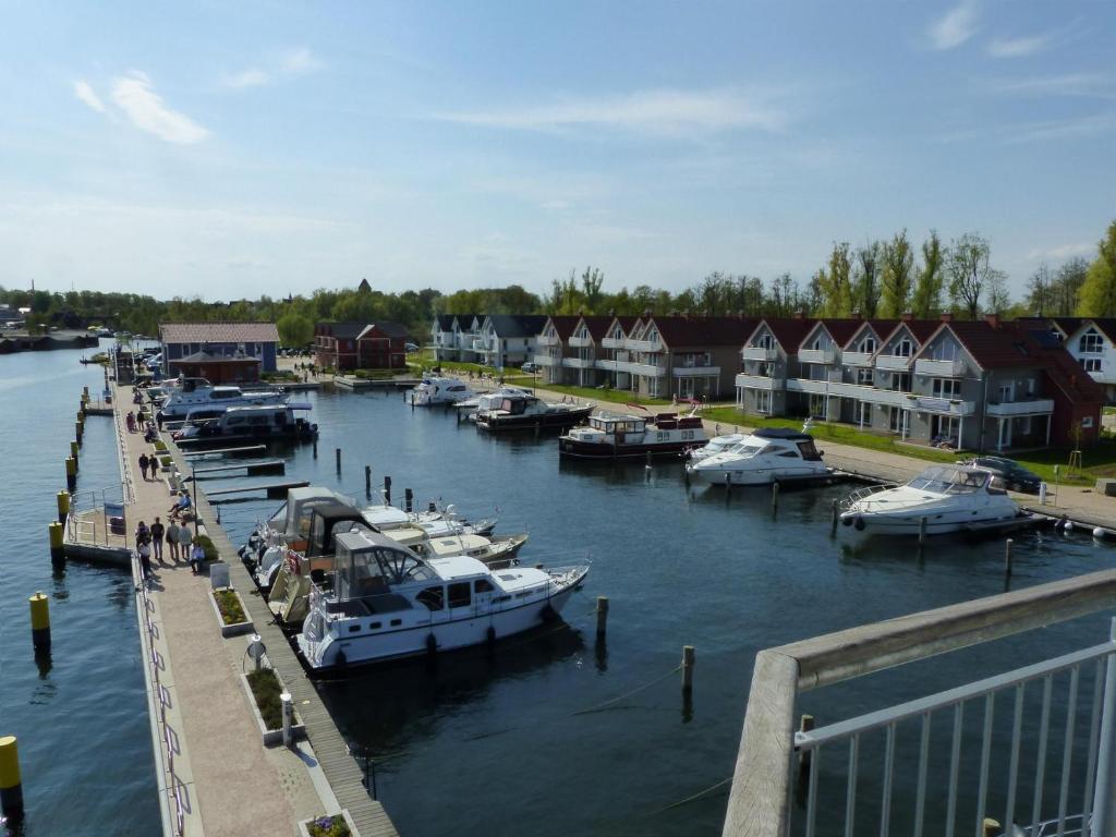 a group of boats docked at a marina with houses at Haus 6 Apartment 3 in Plau am See