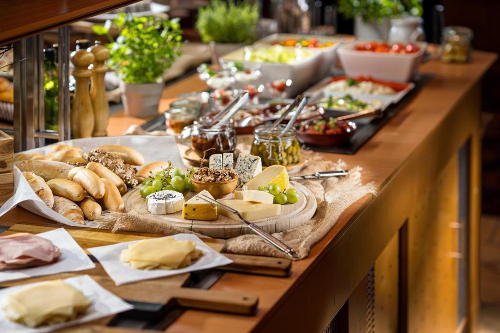 a buffet with a long table filled with food at Quality Hotel Brno Exhibition Centre in Brno