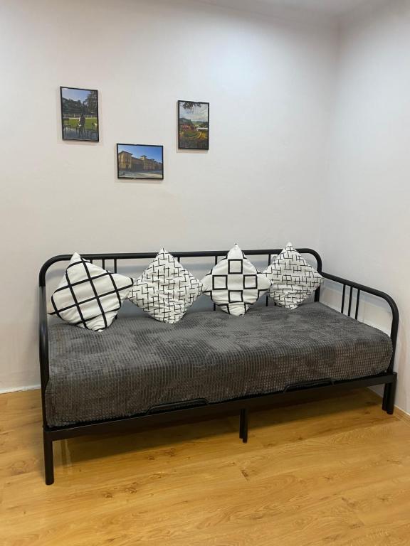 a couch with four pillows on it in a room at Cristal Apartament Krynica - Zdrój in Krynica Zdrój