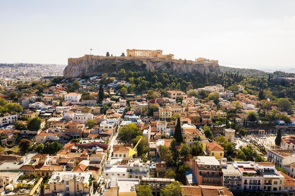 an aerial view of a city with a castle on a hill at The Hadrian Wall - A Historic Acropolis Villa in Athens