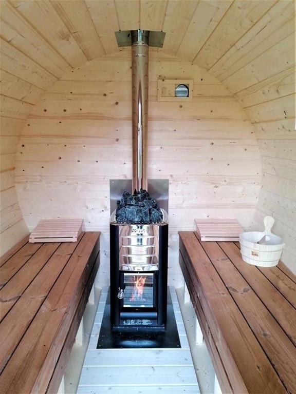 a inside of a sauna with a stove in it at Little Farm Comfort&amp;PrestigeHouse in Ittre