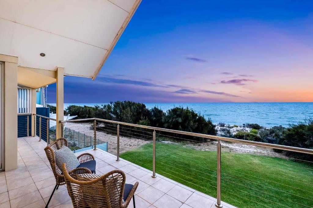 a balcony with chairs and a view of the ocean at Swainson on Paruna in Port Adelaide